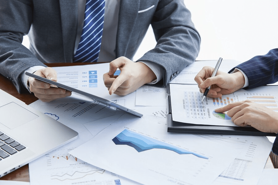 A man in a suit and tie working on papers