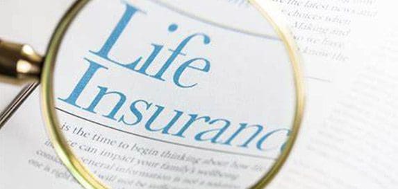 A magnifying glass over the words life insurance.