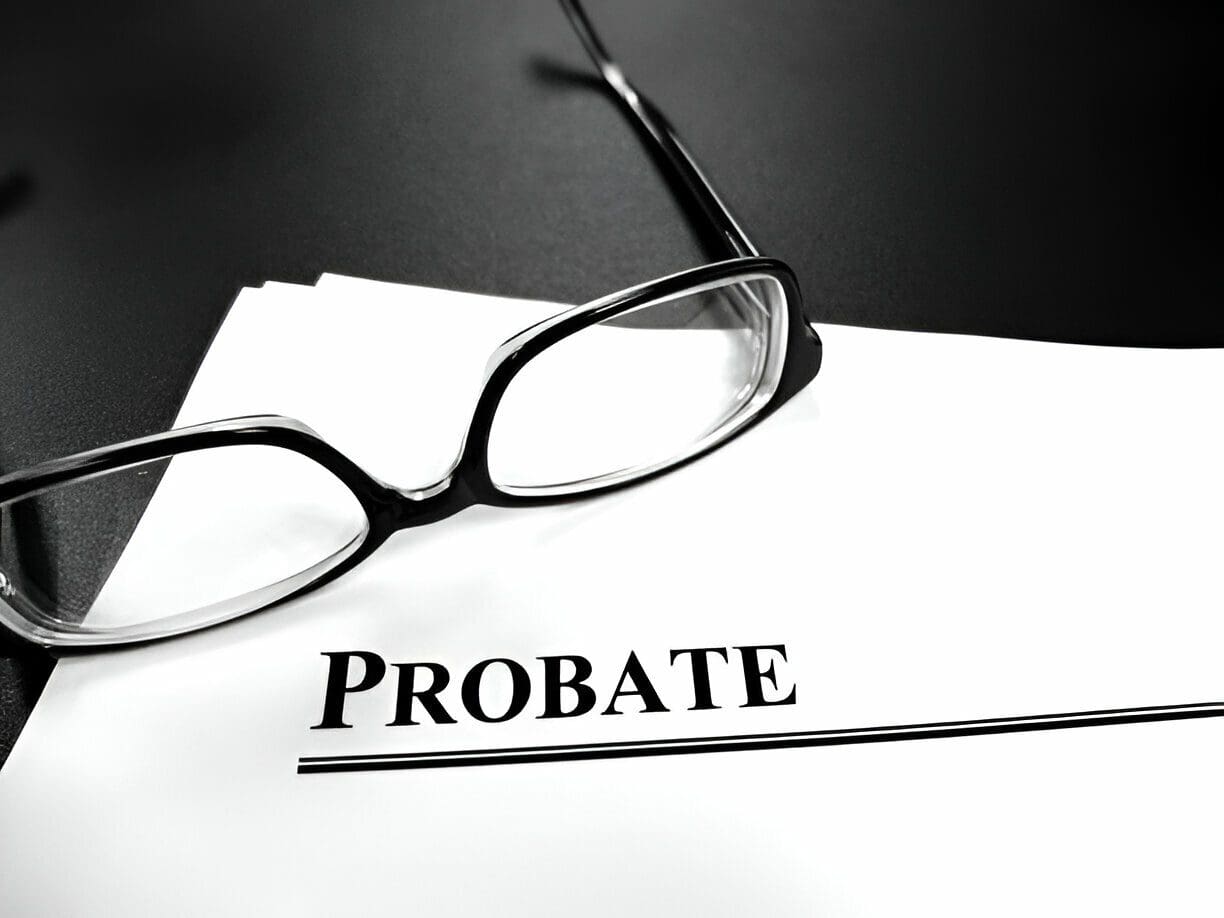 A pair of glasses sitting on top of probate papers.