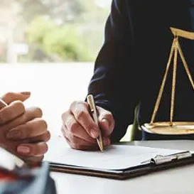 A legal professional discussing financial documents with a client.